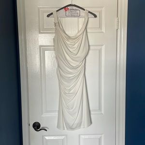 White dress, side zipper with silver accent. Ruching for flattering look.